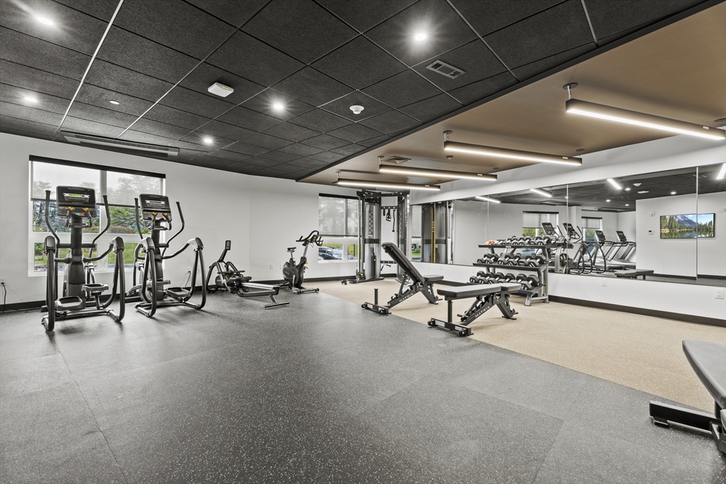 203 Lowell Street, Unit 103 Wilmington, MA 01887 - Photo 29 of 39 a view of a room with gym equipment
