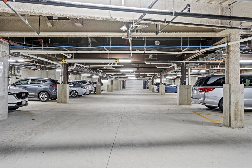 203 Lowell Street, Unit 103 Wilmington, MA 01887 - Photo 31 of 39 a view of parking garage with cars and other equipment