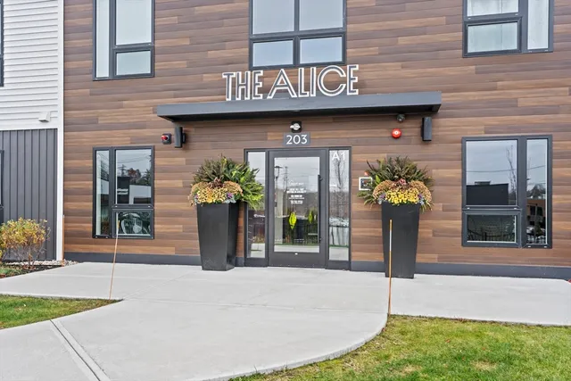 a view of a brick house next to a yard