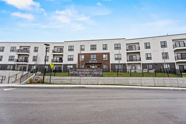 a front view of building with yard