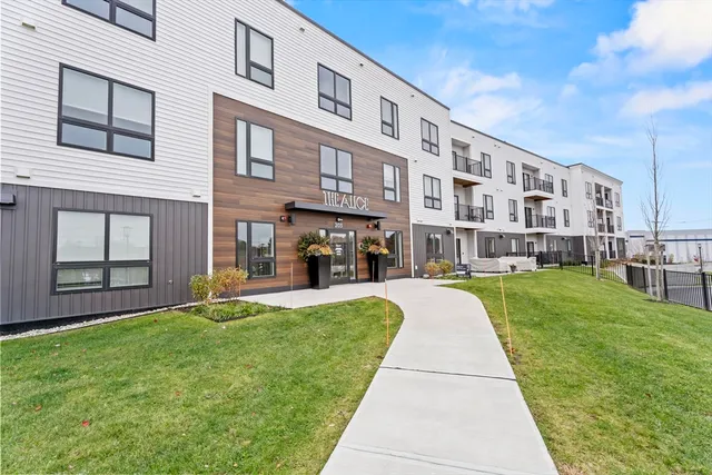 a view of pool with large windows and a big yard