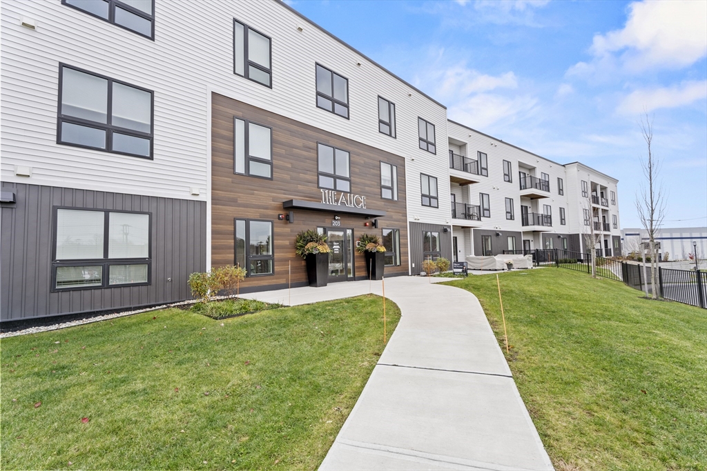 203 Lowell Street, Unit 103 Wilmington, MA 01887 - Photo 37 of 39 a front view of building with yard