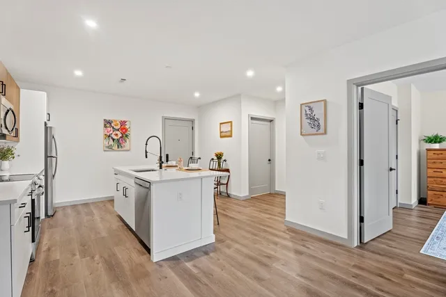 a kitchen with stainless steel appliances a white stove top oven and a refrigerator