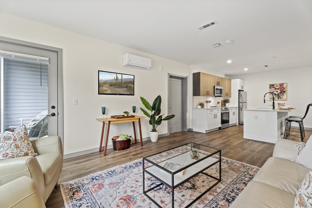 203 Lowell Street, Unit 103 Wilmington, MA 01887 - Photo 6 of 39 a living room with furniture and a table
