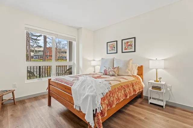 a bedroom with a bed a table and a window