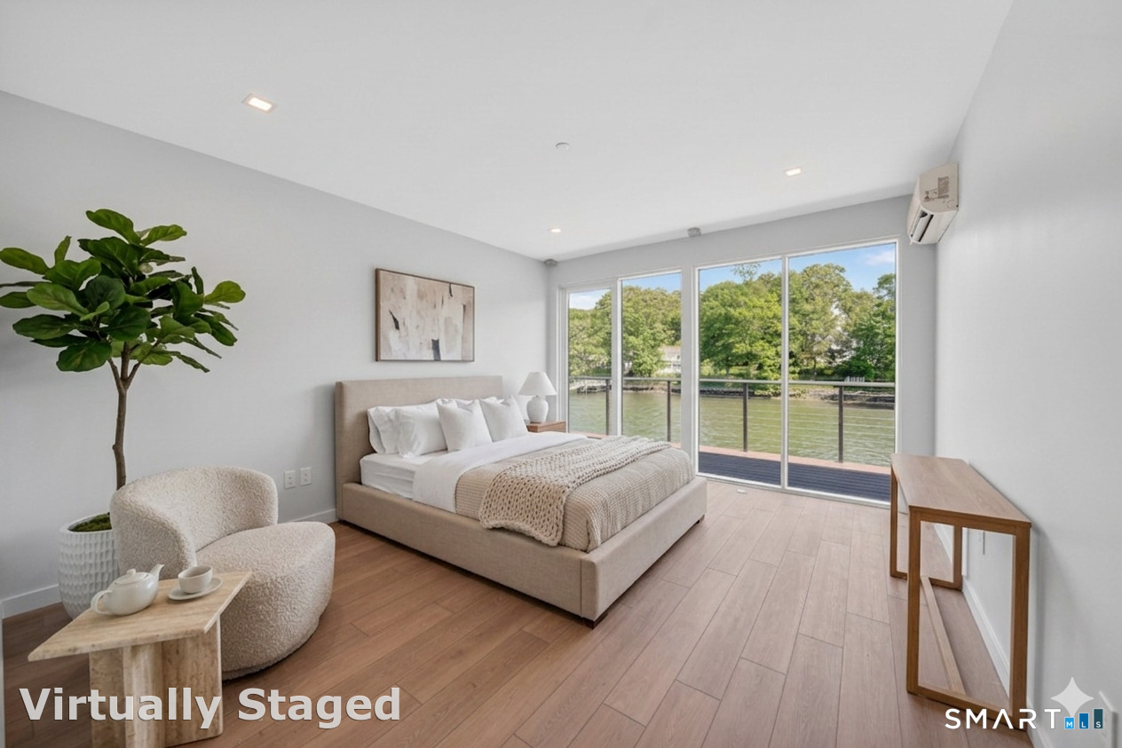 253 Riverside Avenue, Unit 101 Westport, CT 06880 - Photo 6 of 14 a spacious bedroom with a bed and a large window