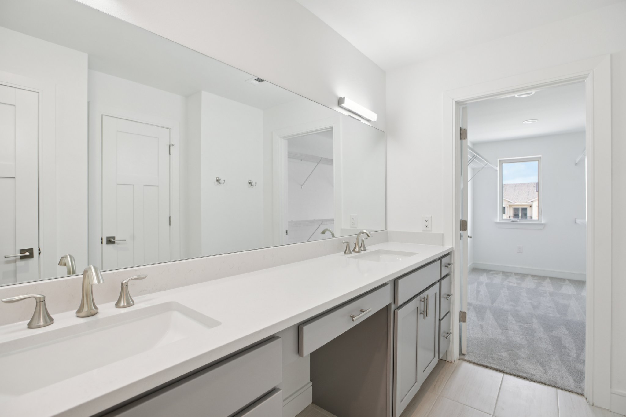 202 Tesla Circle Austin, TX 78681 - Photo 31 of 35 Bathroom featuring double vanity, light carpet, and light tile patterned floors