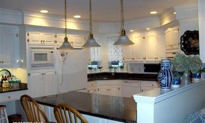 36 Rendezvous Lane Barnstable, MA 02630 - Photo 12 of 23 a kitchen with stainless steel appliances kitchen island granite countertop a stove a sink and a refrigerator