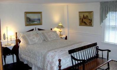 36 Rendezvous Lane Barnstable, MA 02630 - Photo 21 of 23 a bedroom with a bed and a chandelier