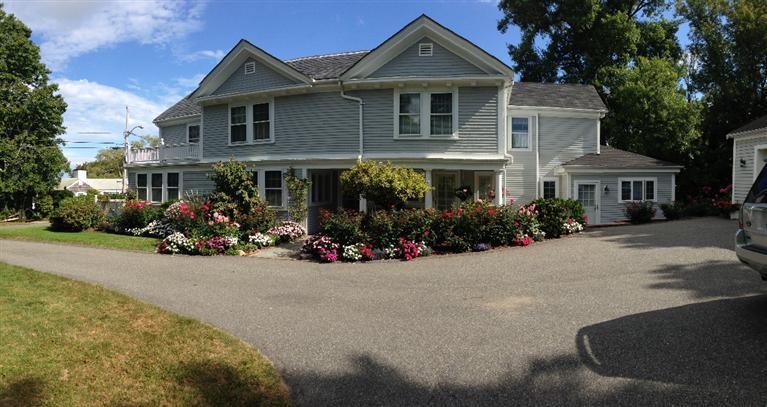 36 Rendezvous Lane Barnstable, MA 02630 - Photo 5 of 23 a front view of a house with lots of trees