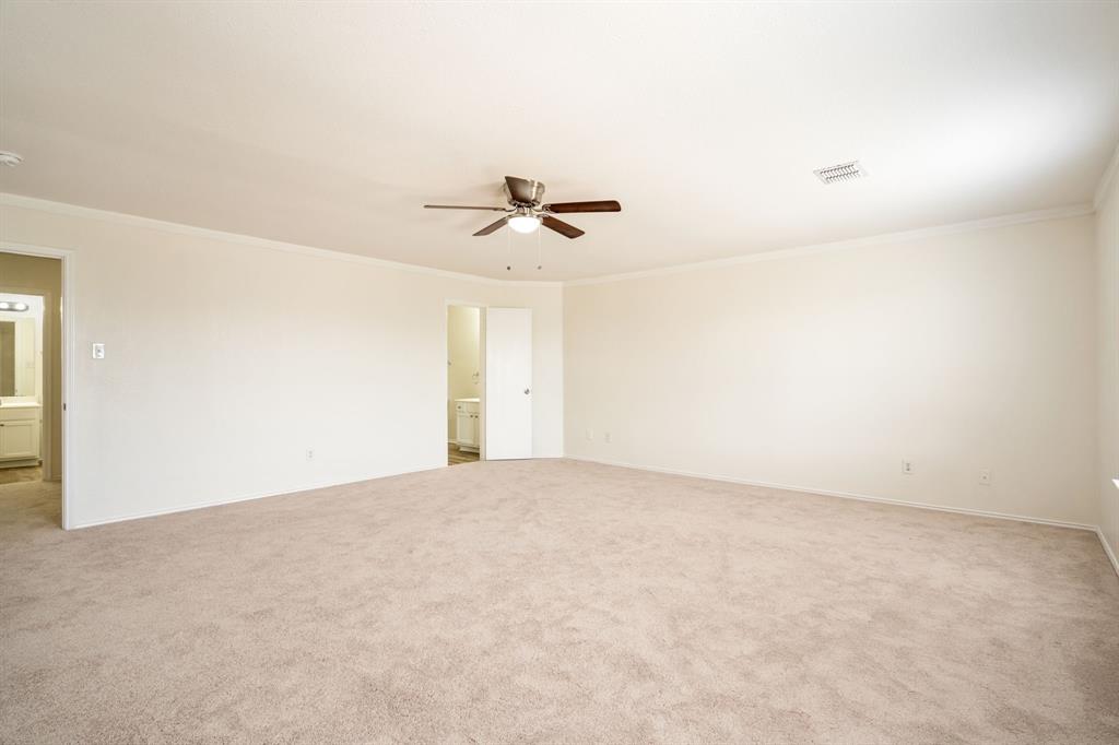 1626 White Oak Road Anna, TX 75409 - Photo 27 of 30 an empty room with a ceiling fan and a window