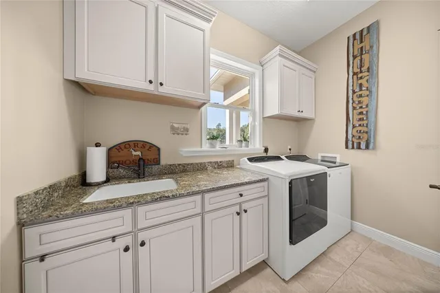a spacious bedroom with a bed couch and window