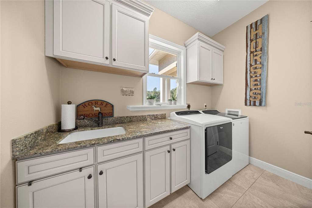 4681 Northwest 101st St Road Ocala, FL 34482 - Photo 13 of 33 a kitchen with granite countertop white cabinets and white appliances
