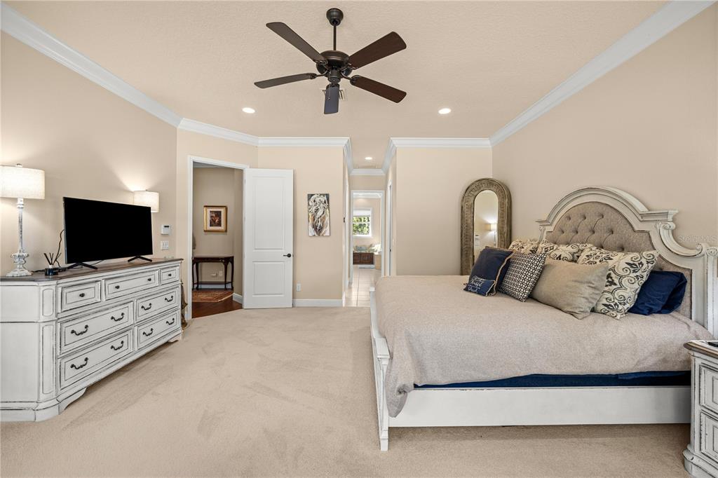 4681 Northwest 101st St Road Ocala, FL 34482 - Photo 16 of 33 a bedroom with a large bed and flat tv screen