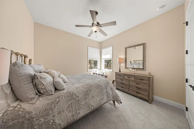 a bedroom with a bed and ceiling fan
