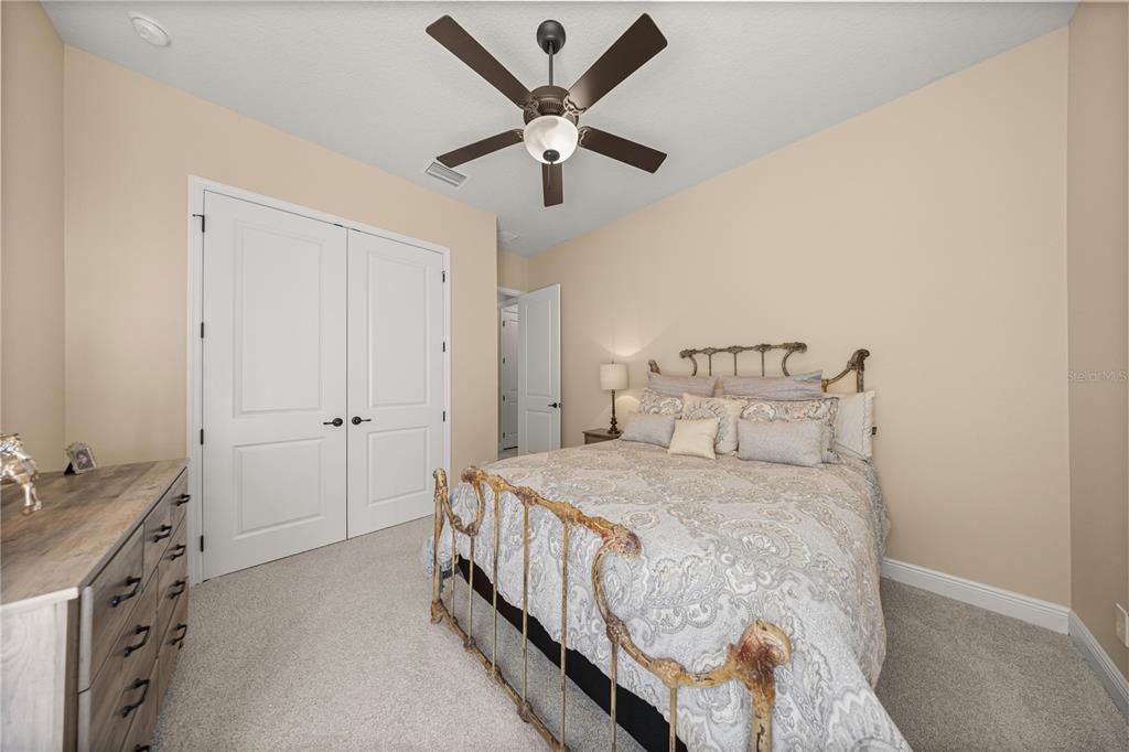 4681 Northwest 101st St Road Ocala, FL 34482 - Photo 24 of 33 a bedroom with a bed and ceiling fan