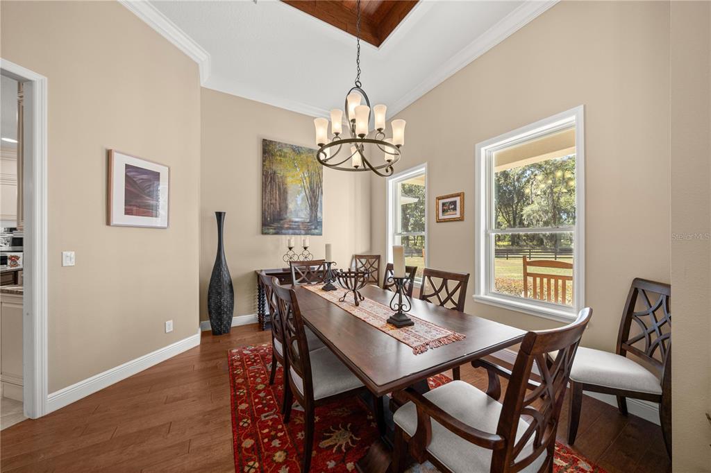 4681 Northwest 101st St Road Ocala, FL 34482 - Photo 8 of 33 a view of a dining room with furniture window and wooden floor