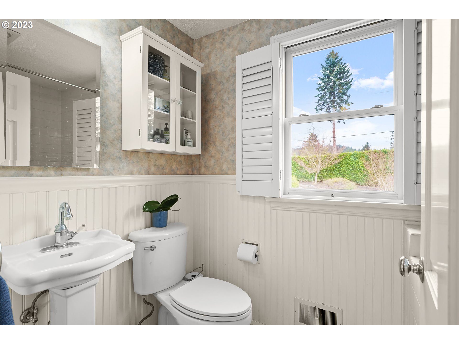 13030 Southwest Fischer Road Tigard, OR 97224 - Photo 16 of 27 a bathroom with a toilet a sink a window and mirror