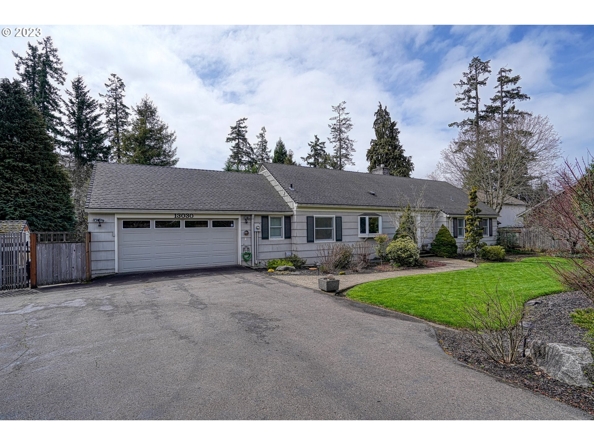 13030 Southwest Fischer Road Tigard, OR 97224 - Photo 2 of 27 a front view of a house with a garden