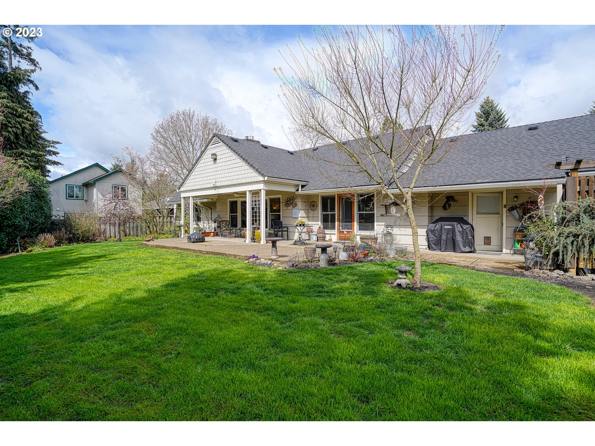 13030 Southwest Fischer Road Tigard, OR 97224 - Photo 22 of 27 a front view of a house with a yard table and chairs