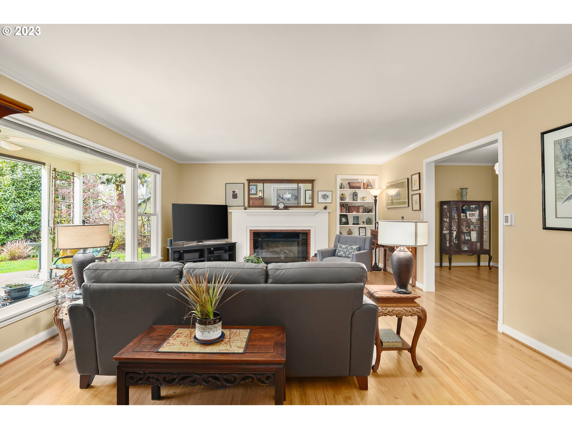 13030 Southwest Fischer Road Tigard, OR 97224 - Photo 6 of 27 a living room with furniture a fireplace and a large window