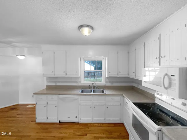 a kitchen that has a sink and a stove