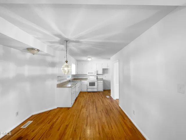 a view of a kitchen with wooden floor