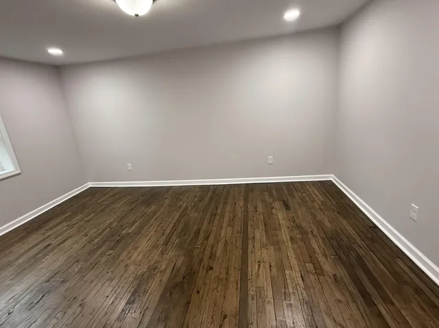 a view of room with wooden floor