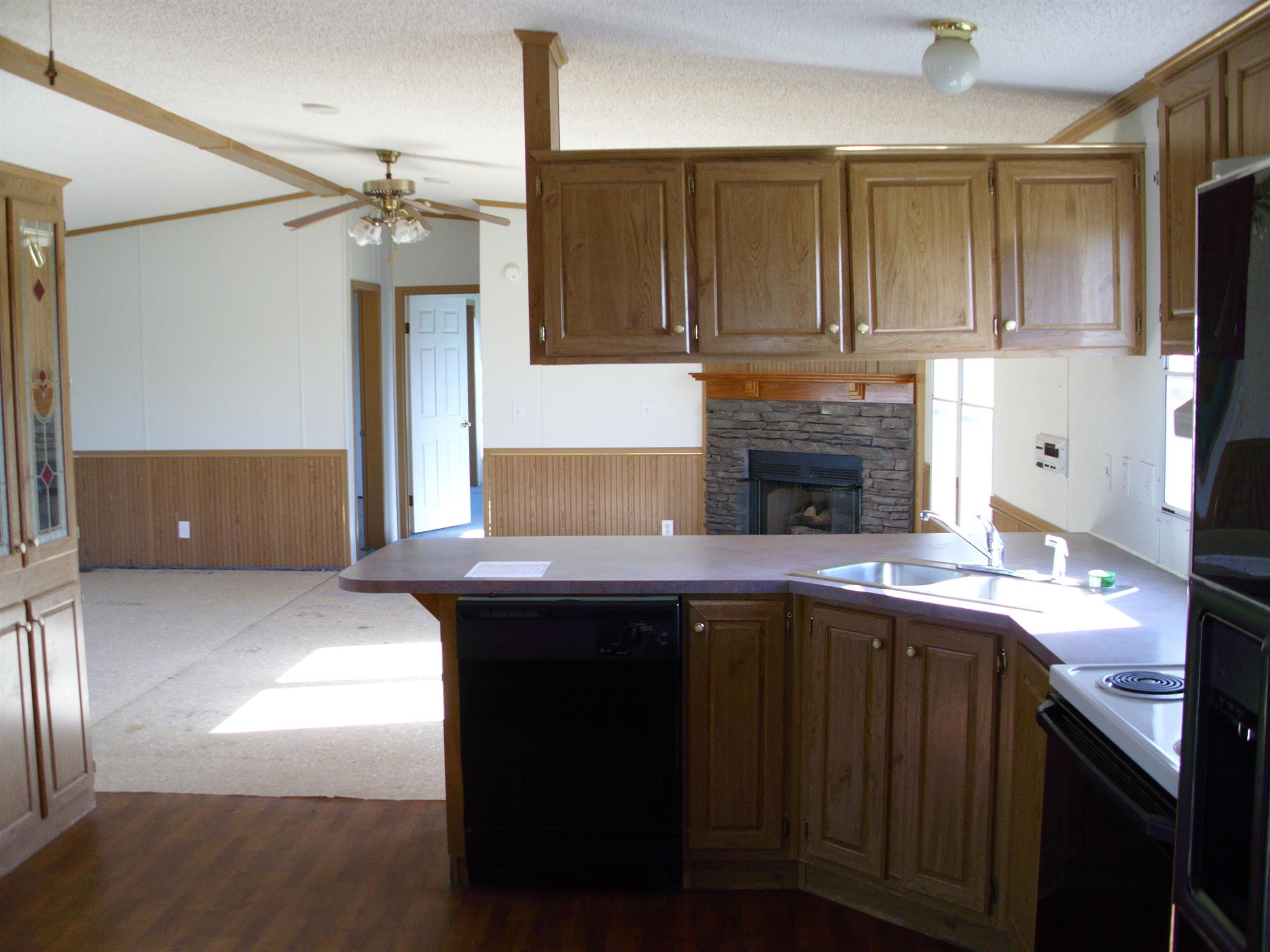 3763 Hoods Branch Road Springfield, TN 37172 - Photo 8 of 15 a kitchen with stainless steel appliances granite countertop a sink and dishwasher with wooden cabinets