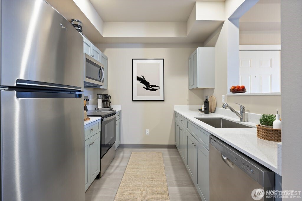 1202 East 72nd Street Tacoma, WA 98404 - Photo 15 of 25 a kitchen with a refrigerator and a sink