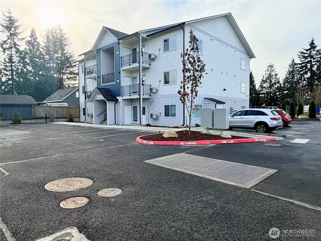 a view of a white house with a yard