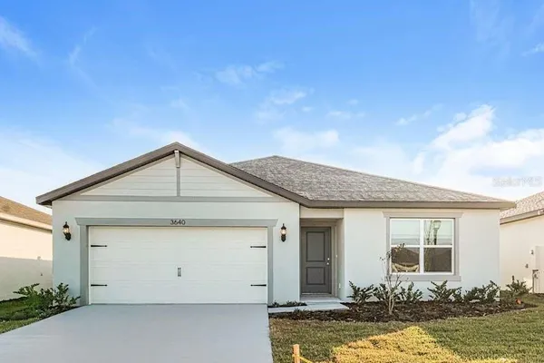 a front view of a house with a yard garage and outdoor seating