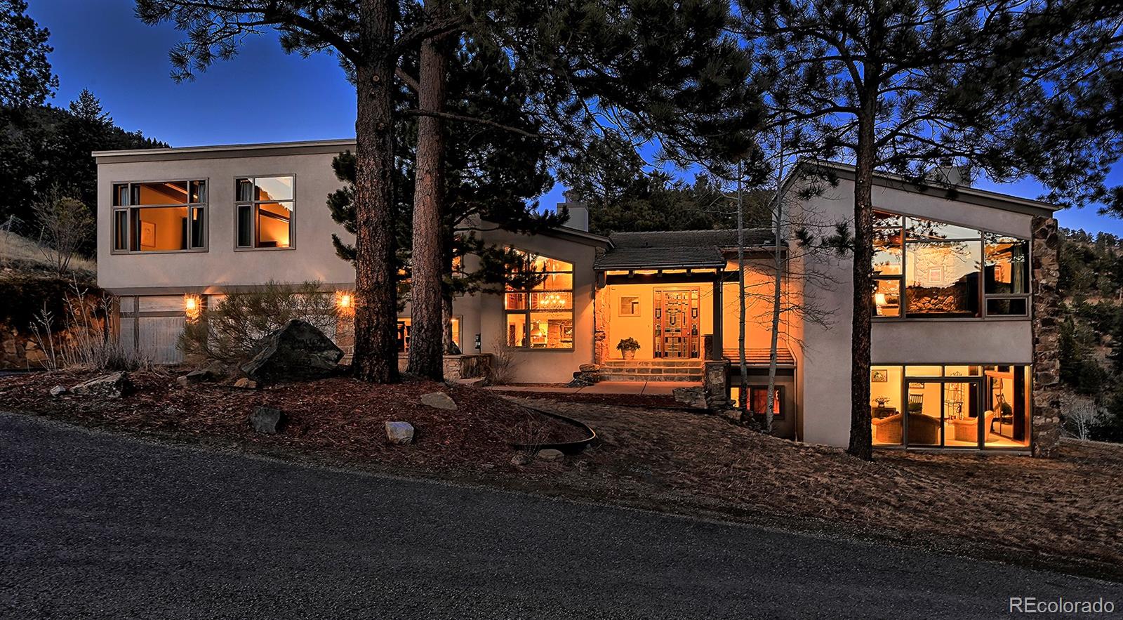 134 Cedar Way Evergreen, CO 80439 - Photo 1 of 40 a front view of a house with a yard