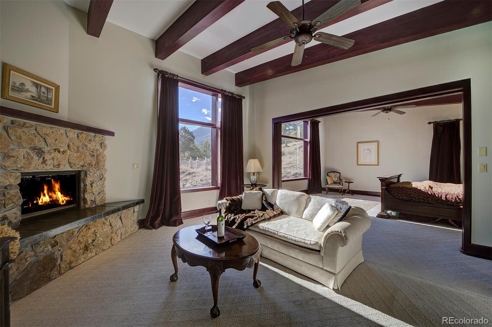 134 Cedar Way Evergreen, CO 80439 - Photo 24 of 40 a living room with furniture and a fireplace