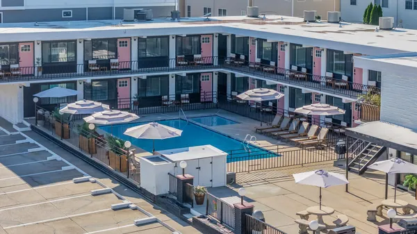 a roof deck with glass table and chairs