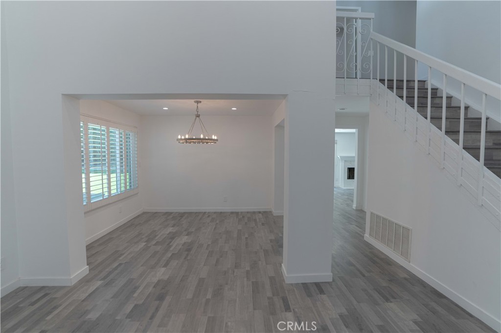 12230 Stewarton Drive Porter Ranch, CA 91326 - Photo 11 of 37 a view of an empty room with wooden floor and a window