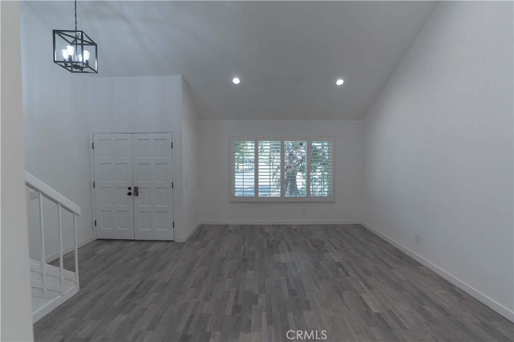 12230 Stewarton Drive Porter Ranch, CA 91326 - Photo 13 of 37 wooden floor in an empty room with a window