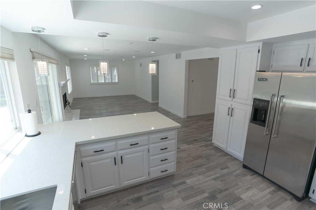12230 Stewarton Drive Porter Ranch, CA 91326 - Photo 17 of 37 a kitchen with white cabinets and refrigerator