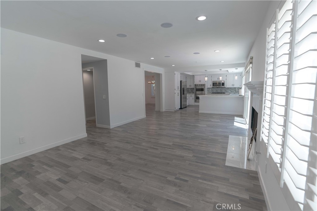 12230 Stewarton Drive Porter Ranch, CA 91326 - Photo 20 of 37 a view of empty room with wooden floor