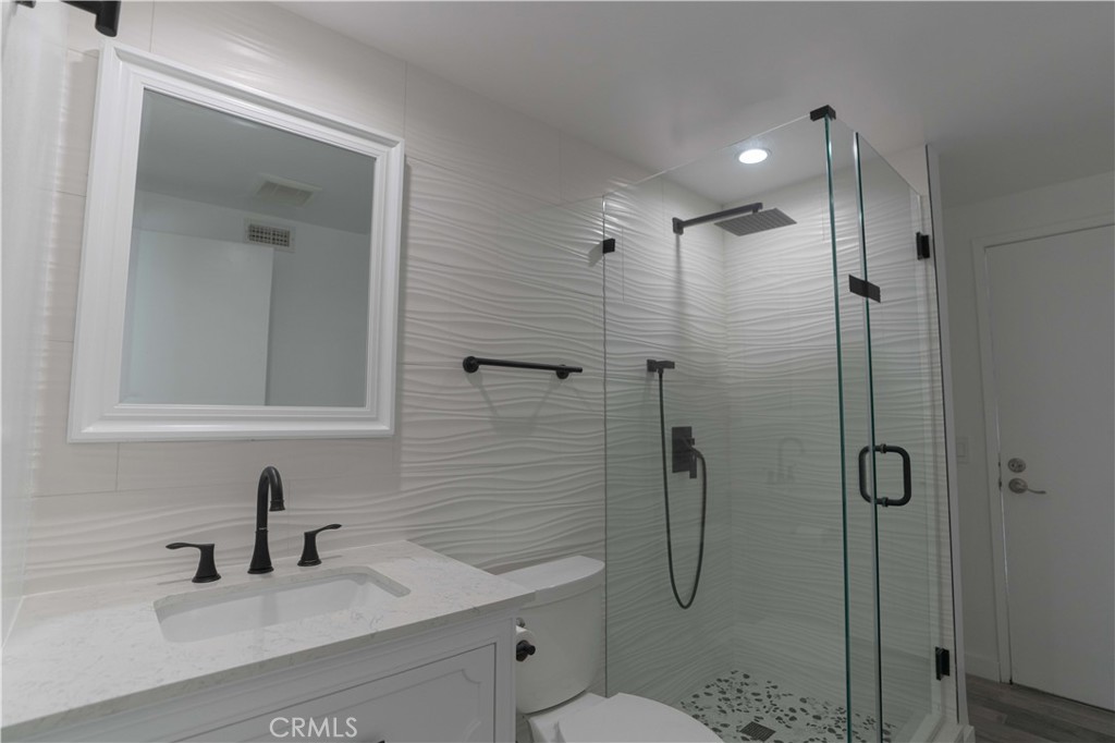 12230 Stewarton Drive Porter Ranch, CA 91326 - Photo 21 of 37 a bathroom with a shower sink vanity and toilet