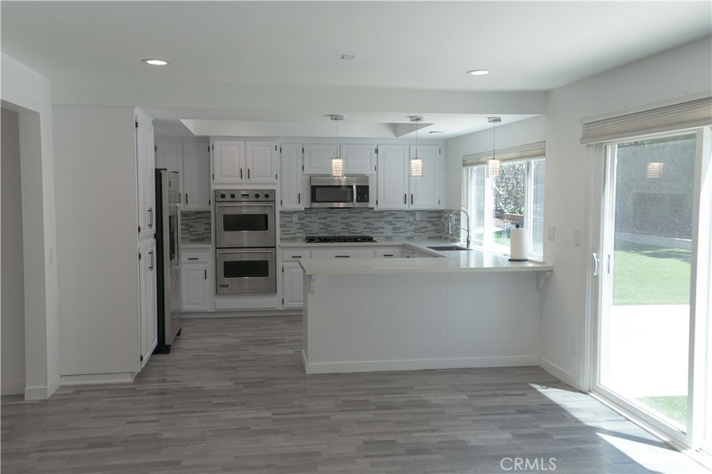 12230 Stewarton Drive Porter Ranch, CA 91326 - Photo 23 of 37 a view of kitchen with wooden floor