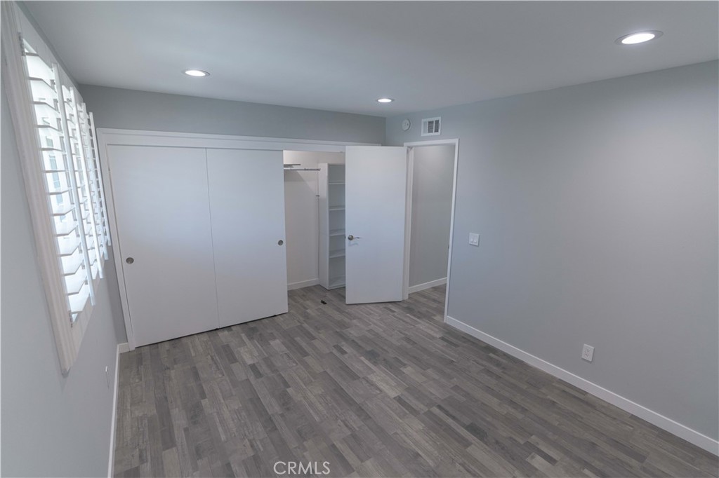 12230 Stewarton Drive Porter Ranch, CA 91326 - Photo 25 of 37 an empty room with wooden floor and windows