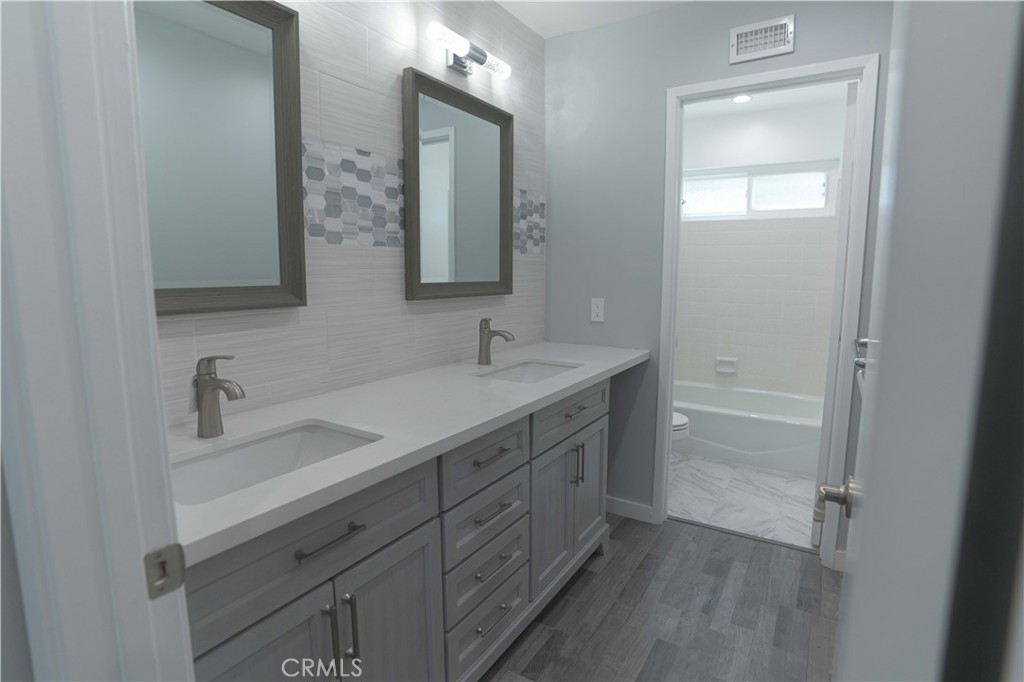 12230 Stewarton Drive Porter Ranch, CA 91326 - Photo 27 of 37 a bathroom with a sink double vanity and a mirror