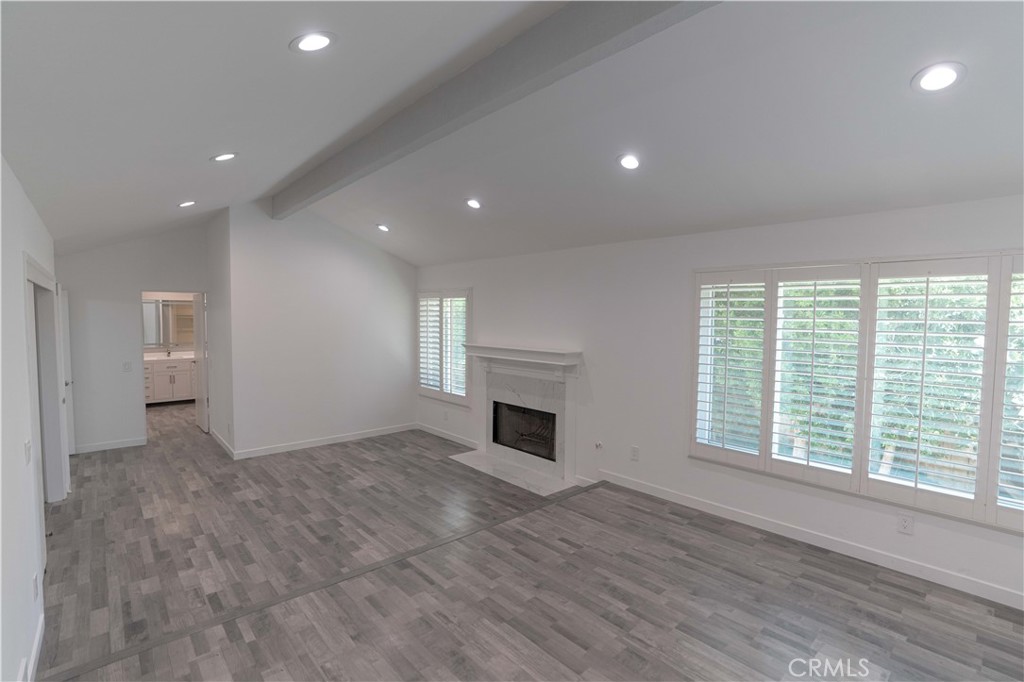 12230 Stewarton Drive Porter Ranch, CA 91326 - Photo 30 of 37 an empty room with windows and fireplace