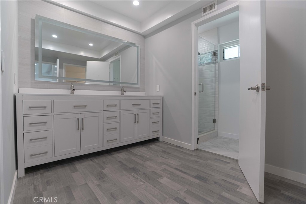 12230 Stewarton Drive Porter Ranch, CA 91326 - Photo 31 of 37 a bathroom with a granite countertop sink mirror and