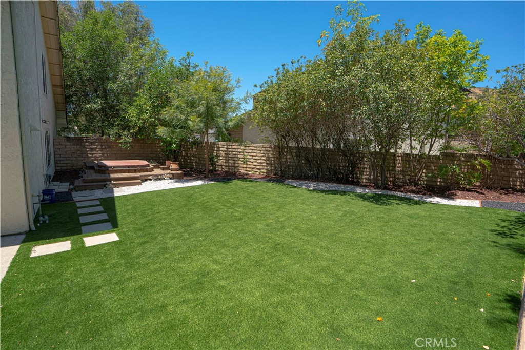 12230 Stewarton Drive Porter Ranch, CA 91326 - Photo 34 of 37 a view of a backyard with a garden