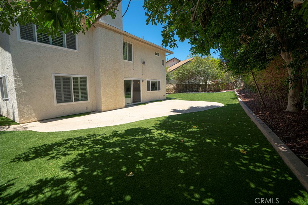 12230 Stewarton Drive Porter Ranch, CA 91326 - Photo 35 of 37 a view of a house with a yard and potted plants