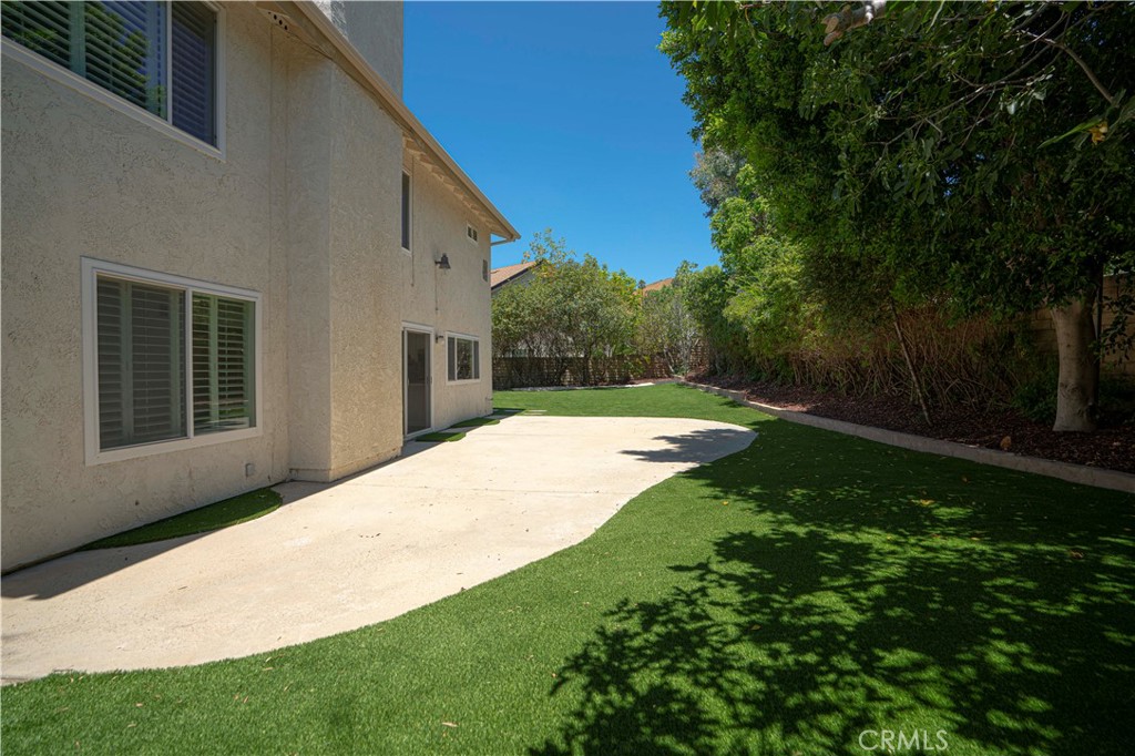 12230 Stewarton Drive Porter Ranch, CA 91326 - Photo 36 of 37 a view of a backyard with a garden and pathway