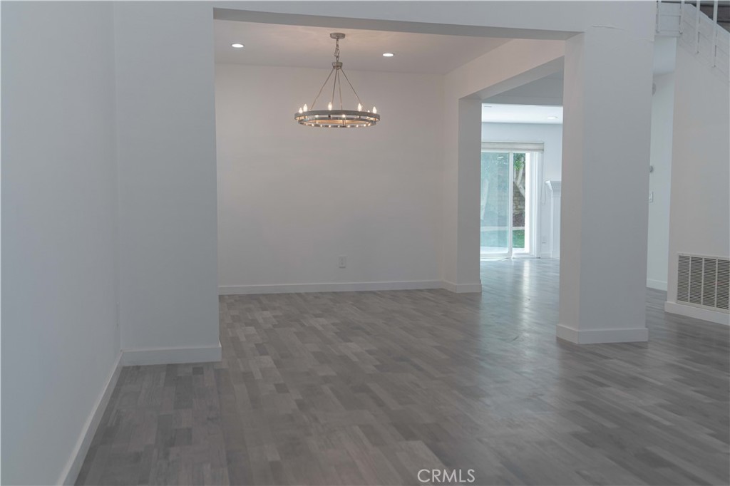 12230 Stewarton Drive Porter Ranch, CA 91326 - Photo 6 of 37 wooden floor in an empty room with a window