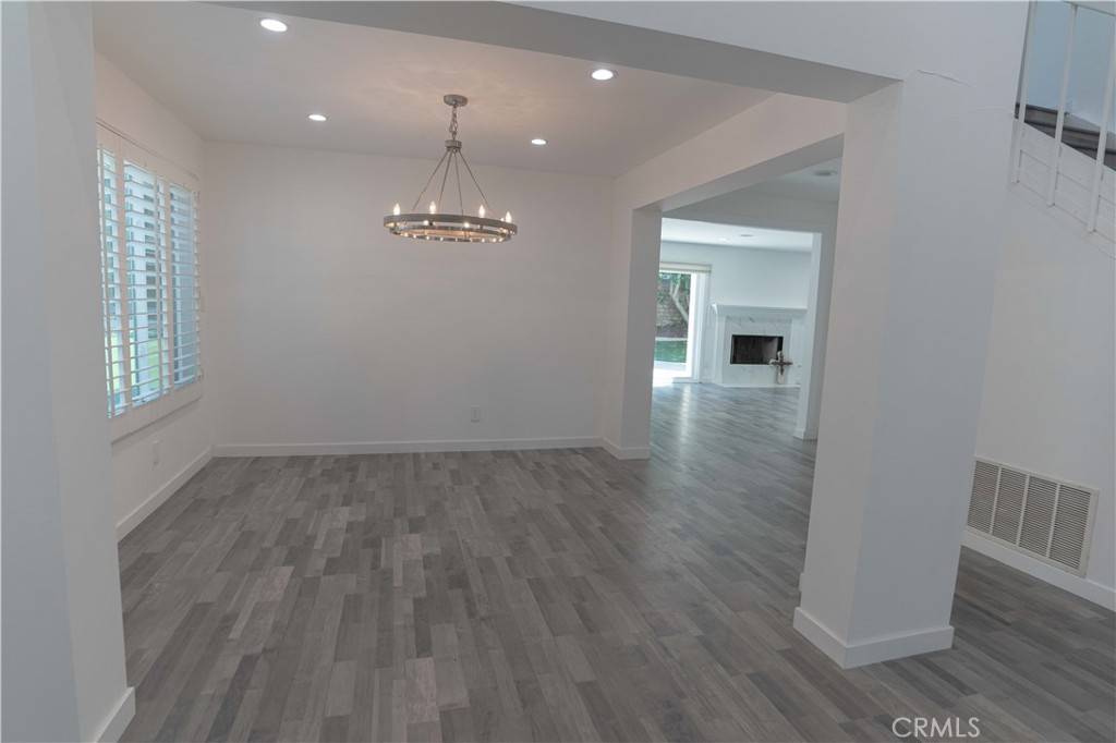 12230 Stewarton Drive Porter Ranch, CA 91326 - Photo 7 of 37 wooden floor in an empty room with a window